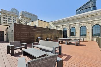 A wooden deck with a bench and a table.